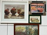 many pictures hanging on the wall of a bathroom