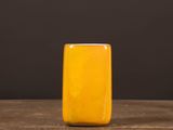 a yellow soap bar sitting on top of a wooden table