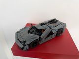 une maquette Lego représentant une voiture posée sur une plate-forme rouge