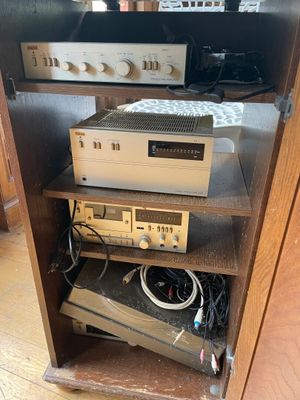 a shelf that has a bunch of electronics on top of it