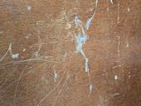 a close up of a piece of wood with some paint on it