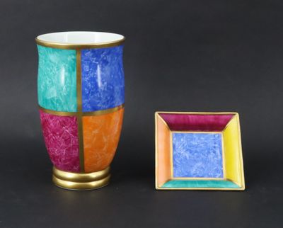a vase and a picture frame sitting next to each other