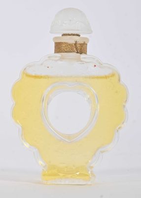 a small glass bottle with a heart inside of it