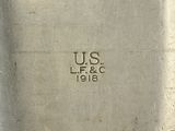 a close up of a silver plate with a us e f c stamp on it