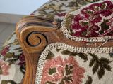 an upholstered upholstered chair with a floral pattern on it