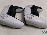 two video game controllers sitting next to each other on a table