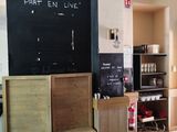 a blackboard on the wall of a coffee shop