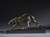 an image of a bronze sculpture of a cheetah on a marble base