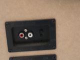 two speakers on the table with wires attached to them