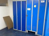 several blue lockers in a room with a blue floor
