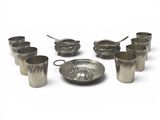 a lot of silver cups and spoons on the table