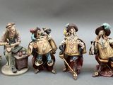 seven figurines of people that are standing in a row