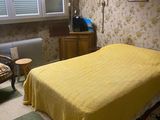 a yellow blanket on a bed in a bedroom