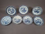 six blue and white plates with flowers on them on a table