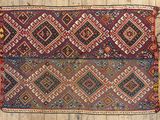 an old rug on a wooden floor with a wooden floor