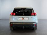 the rear end of a white suv parked in a white room
