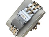 an image of a wrist watch with a silver and gold bracelet
