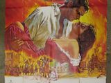 an old movie poster of a man and a woman kissing in front of a fire