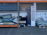two shelves that have books on them in front of a building