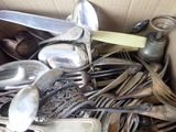 a box full of silver spoons and spoons in it