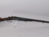 a rifle with a wooden barrel on a white background