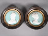 pair of wednestone portraits of a man and a woman