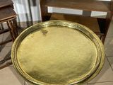 a gold tray sitting on top of a wooden table