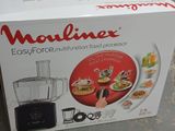 packaging of a food processor sitting on a counter top next to a box