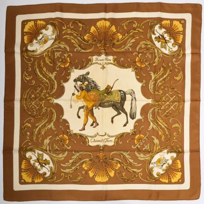a brown and yellow scarf with a horse on it
