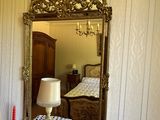 a mirror on the wall above a dresser in a room