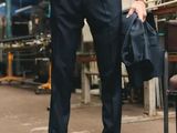 a man that is wearing a tie and suspenders