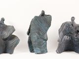 three pieces of art that are sitting on a white surface