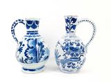 two blue and white vases sitting next to each other