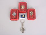 four small red trays with a keychain and a key ring