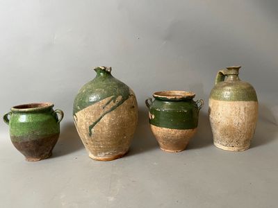 four different types of vases are lined up on a table