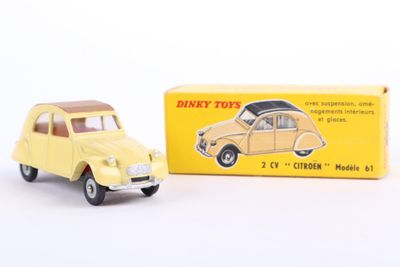 yellow toy car in front of a yellow box on a white surface