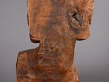 an image of a wooden sculpture of an elephant head on a gray background