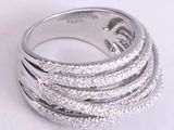 a close up of a silver ring on a white surface