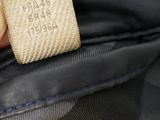 a person holding a black bag with a label on it