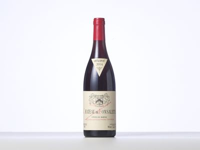 a bottle of red wine sitting on top of a table