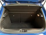a trunk of a blue car with its doors open