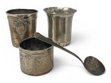 three cups and a spoon sitting next to each other