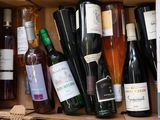many bottles of wine in a box on the table