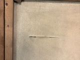 an old picture frame with a piece of wood sticking out of it