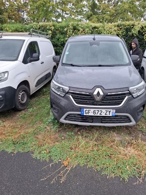 three vans parked next to each other on the side of a road