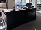 un bureau sur lequel se trouve un ordinateur, dans une grande pièce