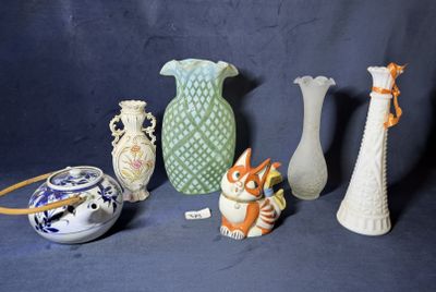 cinq vases et une figurine de chat sur fond bleu