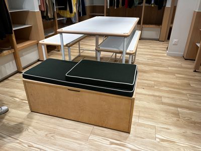 une photo d'un dressing avec une table et un banc