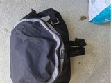 a backpack that is sitting on the floor next to a bag