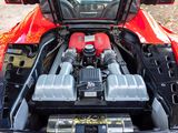a red sports car with its engine in the trunk